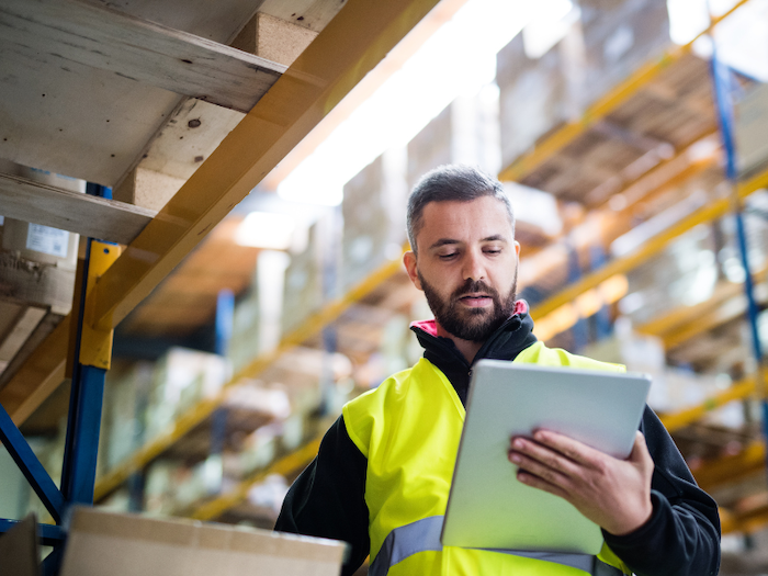 Asset tracking solutions for any business with man conducting an asset audit and verification in a warehouse using assettrac asset management software solution.